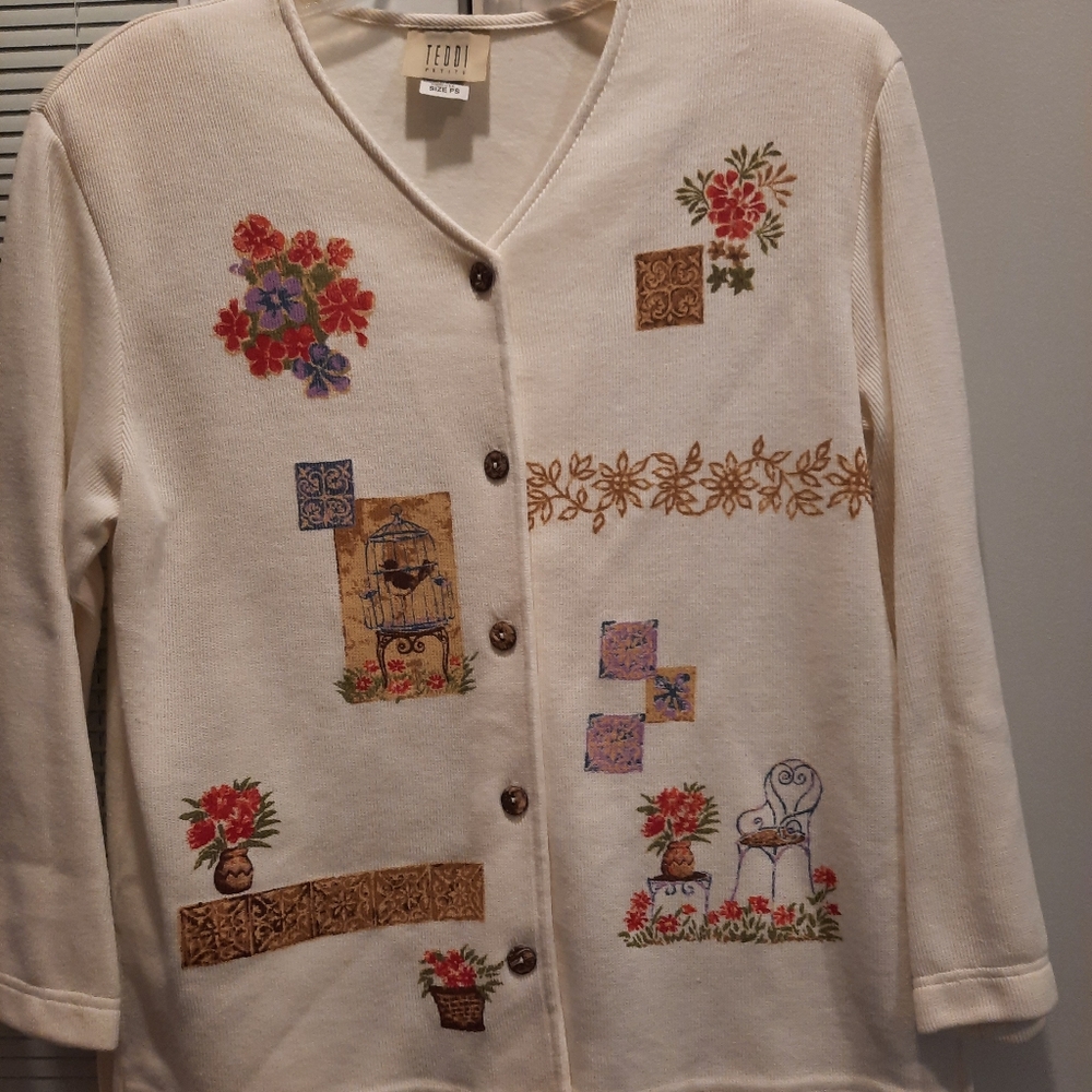 Cream-colored sweater with shoulder pads button up front